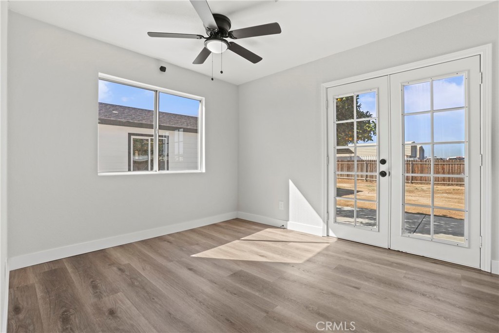 1116 7th Street Calimesa, CA 92320 - Photo 14 of 52 a view of empty room with wooden floor and fan
