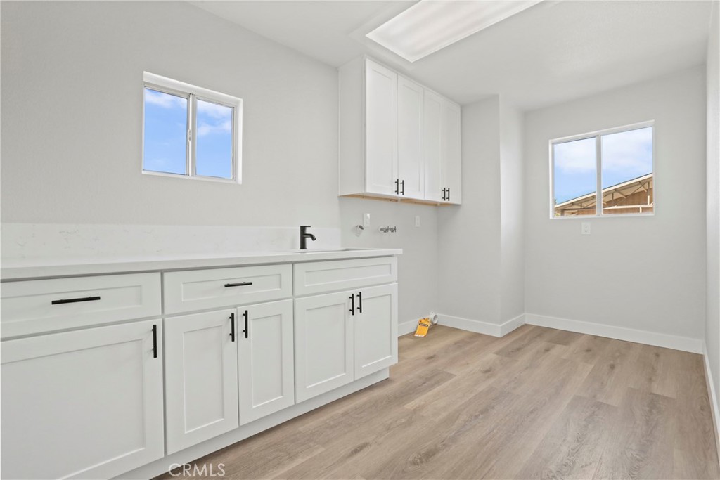 1116 7th Street Calimesa, CA 92320 - Photo 17 of 52 a room with cabinets and wooden floor