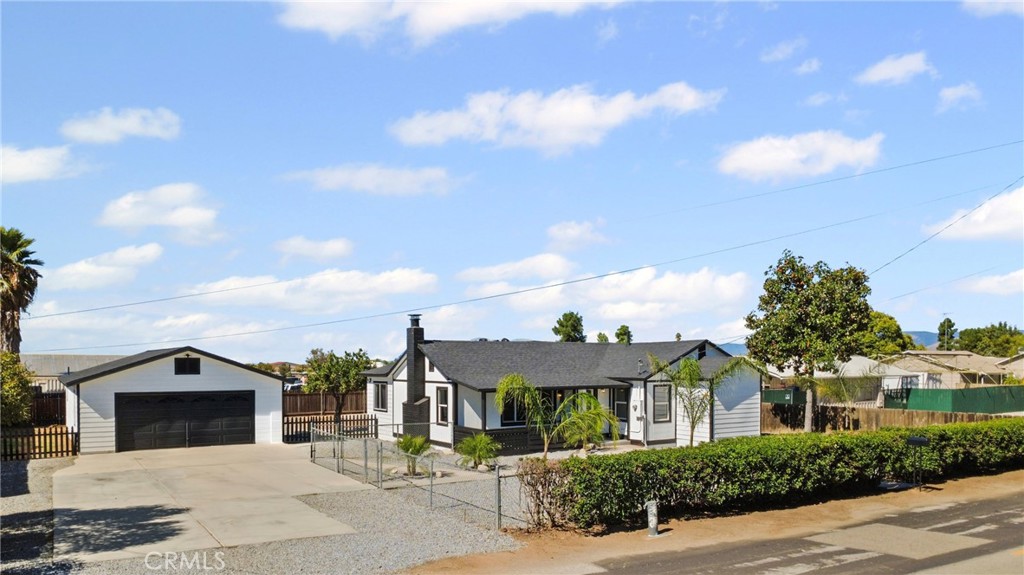 1116 7th Street Calimesa, CA 92320 - Photo 3 of 52 a front view of a house with a garden