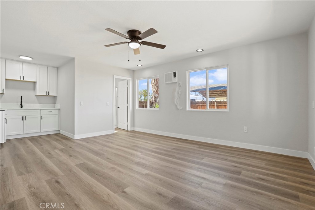 1116 7th Street Calimesa, CA 92320 - Photo 33 of 52 a view of an empty room with a window and wooden floor