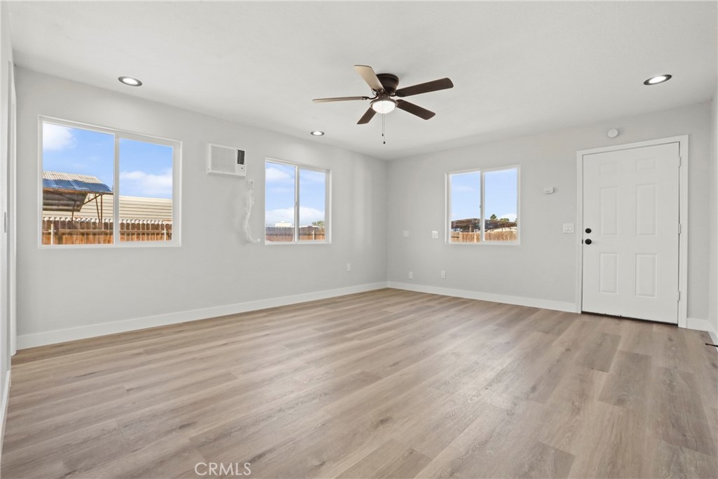 1116 7th Street Calimesa, CA 92320 - Photo 35 of 52 a view of an empty room with a window and wooden floor