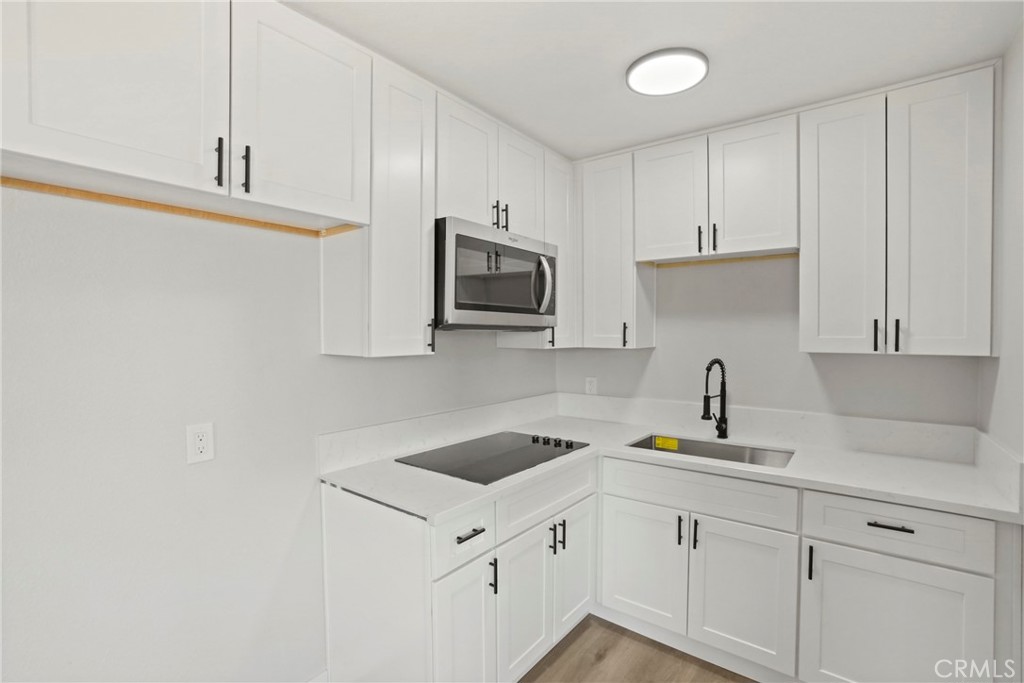 1116 7th Street Calimesa, CA 92320 - Photo 36 of 52 a kitchen with sink cabinets and microwave