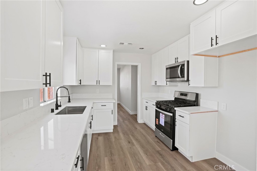 1116 7th Street Calimesa, CA 92320 - Photo 10 of 52 a kitchen with a sink a stove and refrigerator