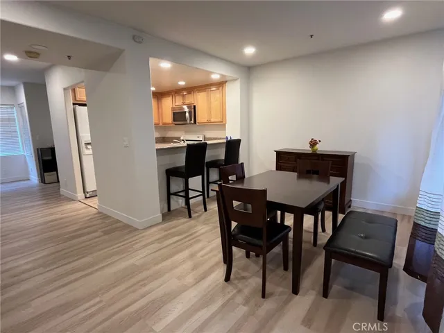a view of a dining room with furniture and wooden floor