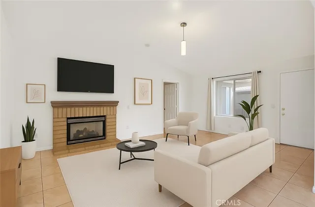 a living room with furniture a fireplace and a flat screen tv