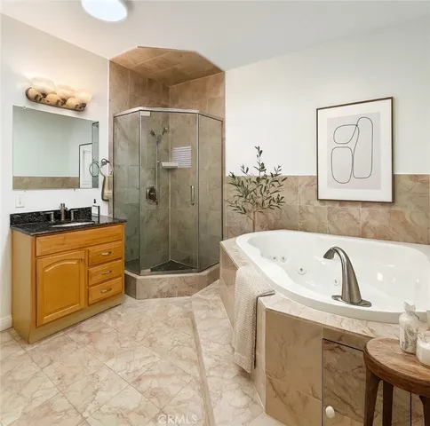 a bathroom with a bathtub sink and mirror