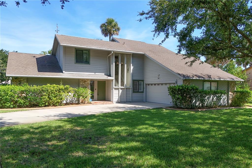 100 Bittern Court Daytona Beach, FL 32119 - Photo 1 of 52 a front view of a house with a yard and garage