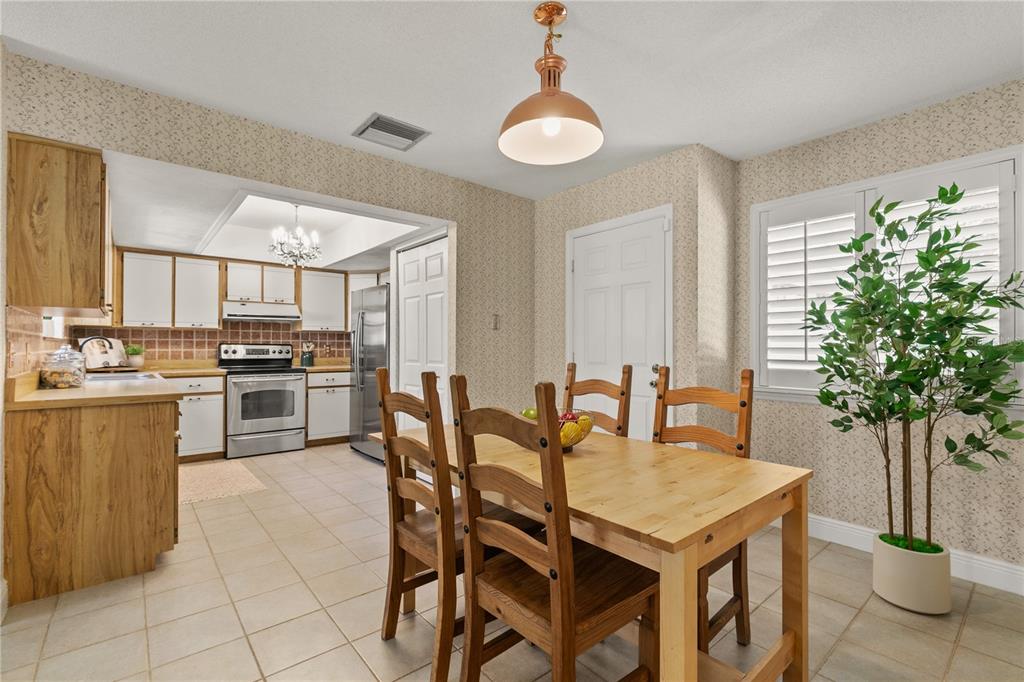 100 Bittern Court Daytona Beach, FL 32119 - Photo 12 of 52 a kitchen with a table and chairs in it