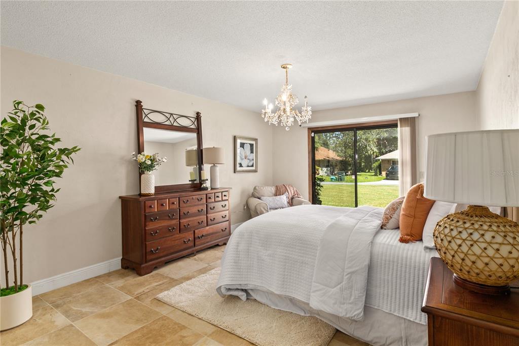 100 Bittern Court Daytona Beach, FL 32119 - Photo 18 of 52 a bed room with a bed and a chandelier