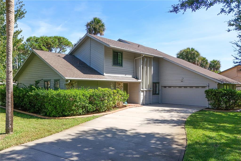100 Bittern Court Daytona Beach, FL 32119 - Photo 2 of 52 a front view of a house with a yard and garage