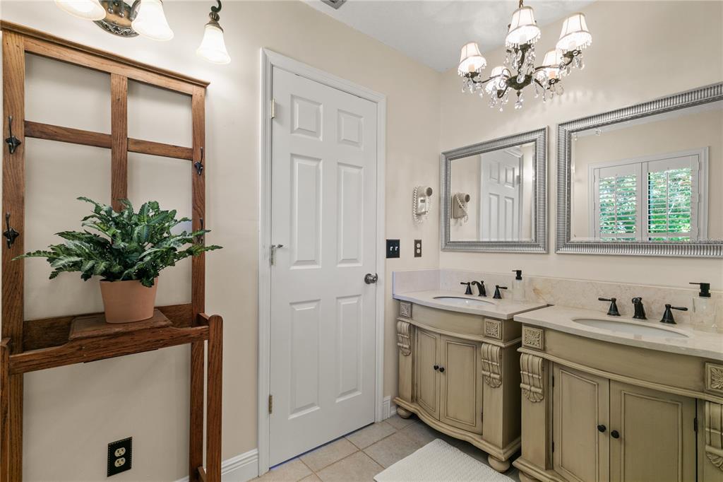 100 Bittern Court Daytona Beach, FL 32119 - Photo 21 of 52 a spacious en suite bathroom with a granite countertop sink a large mirror and a shower