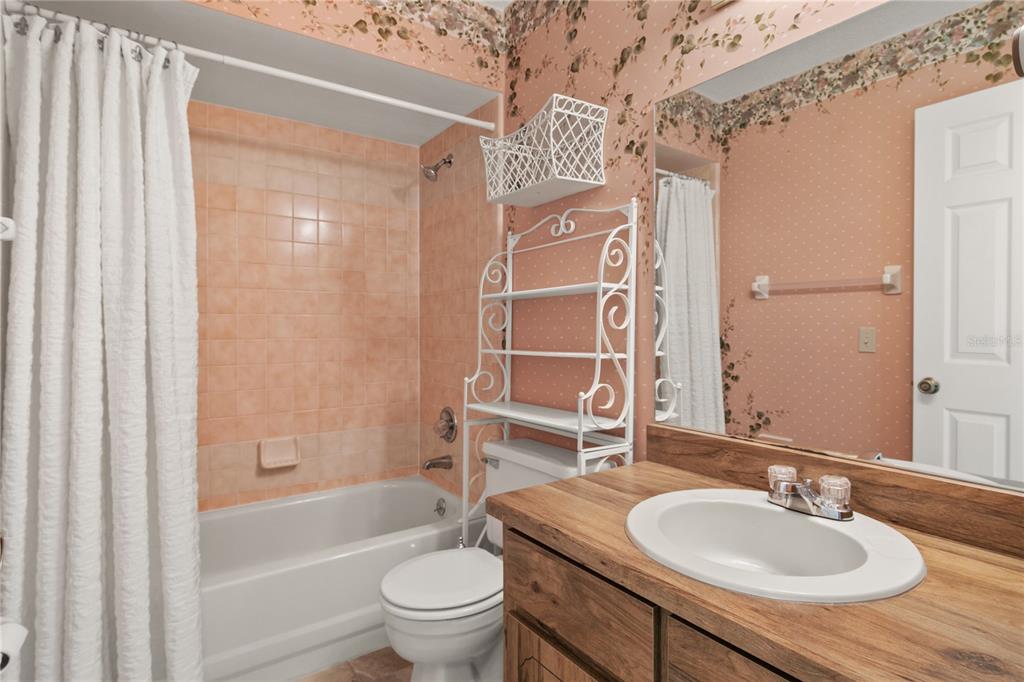 100 Bittern Court Daytona Beach, FL 32119 - Photo 31 of 52 a bathroom with a granite countertop sink toilet and shower