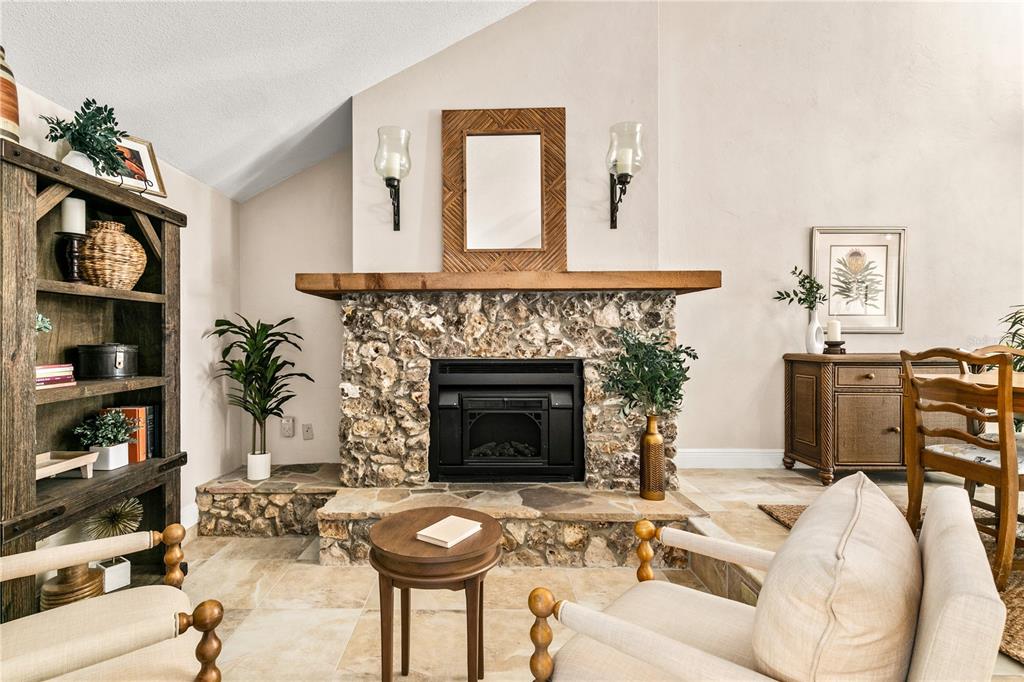 100 Bittern Court Daytona Beach, FL 32119 - Photo 10 of 52 a living room with furniture a fireplace and a flat screen tv