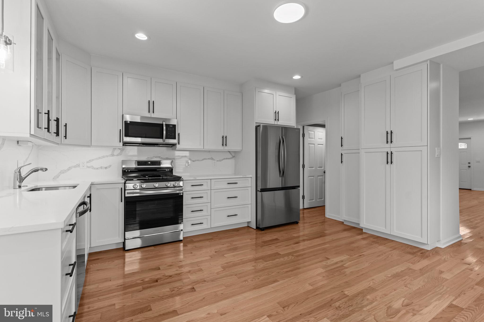 446 Pond Street Bristol, PA 19007 - Photo 1 of 35 a kitchen with stainless steel appliances a refrigerator and a stove top oven