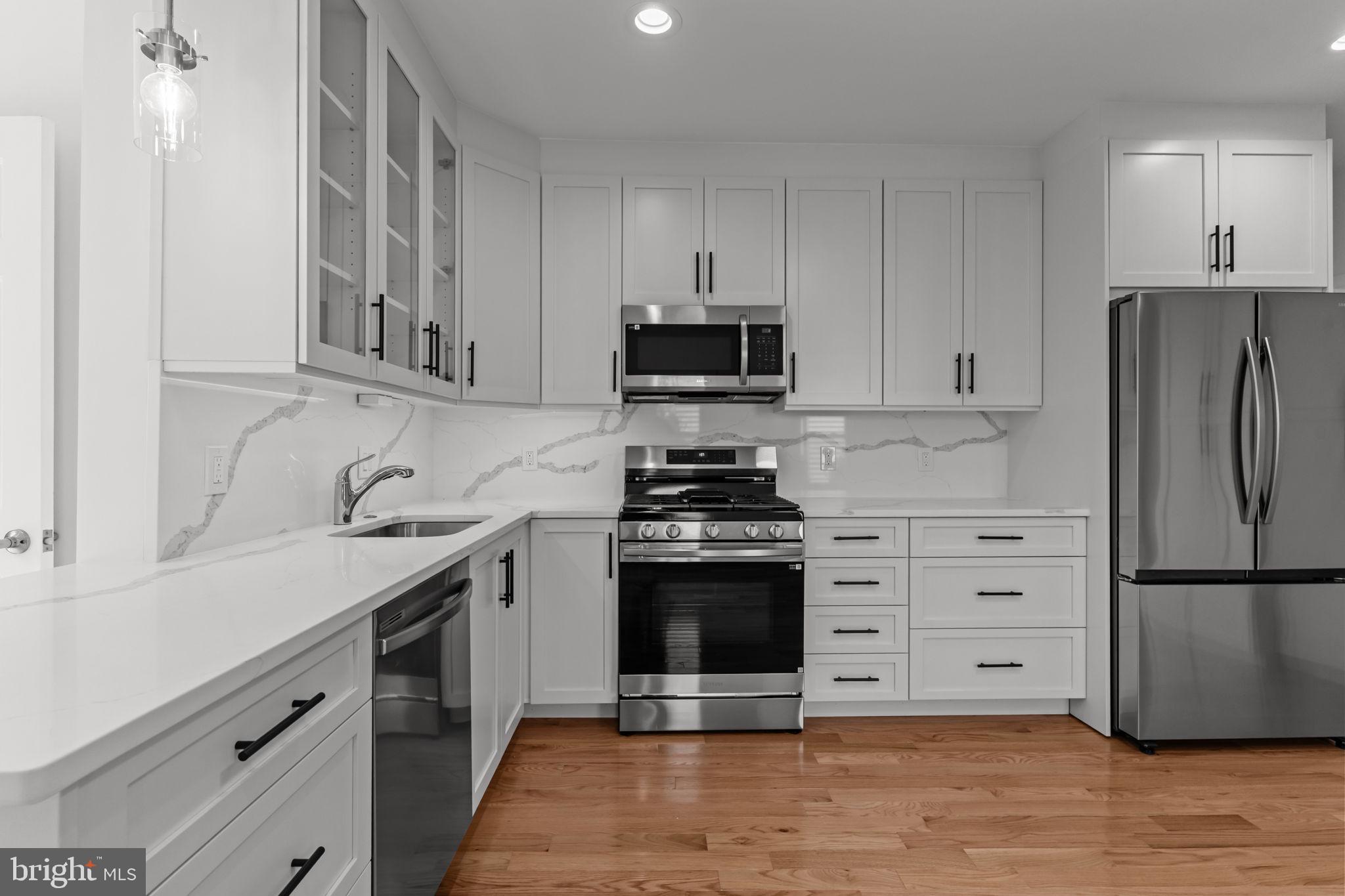446 Pond Street Bristol, PA 19007 - Photo 13 of 35 a kitchen with stainless steel appliances granite countertop a stove a refrigerator and a sink