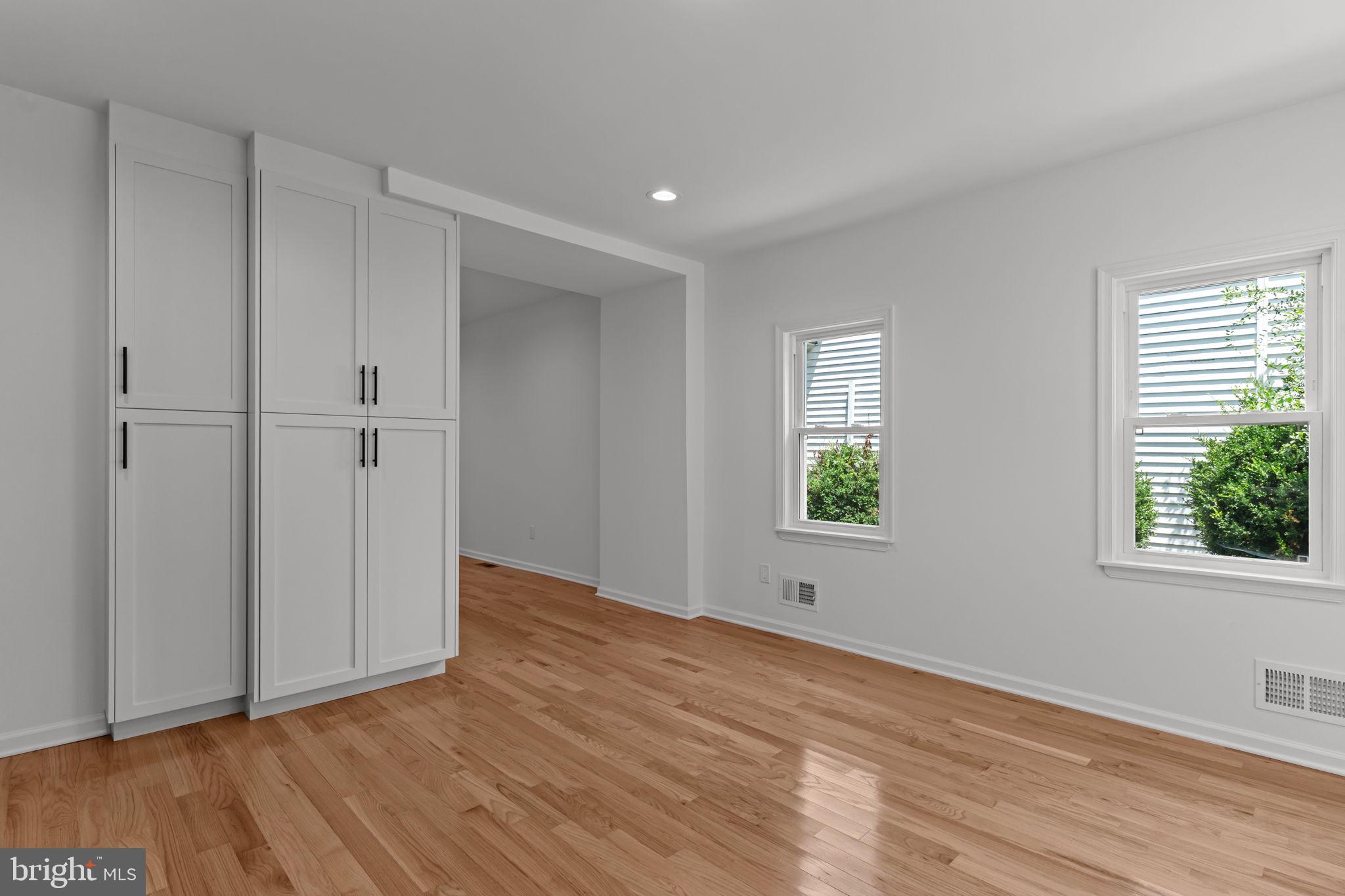 446 Pond Street Bristol, PA 19007 - Photo 15 of 35 a view of an empty room with wooden floor and a window