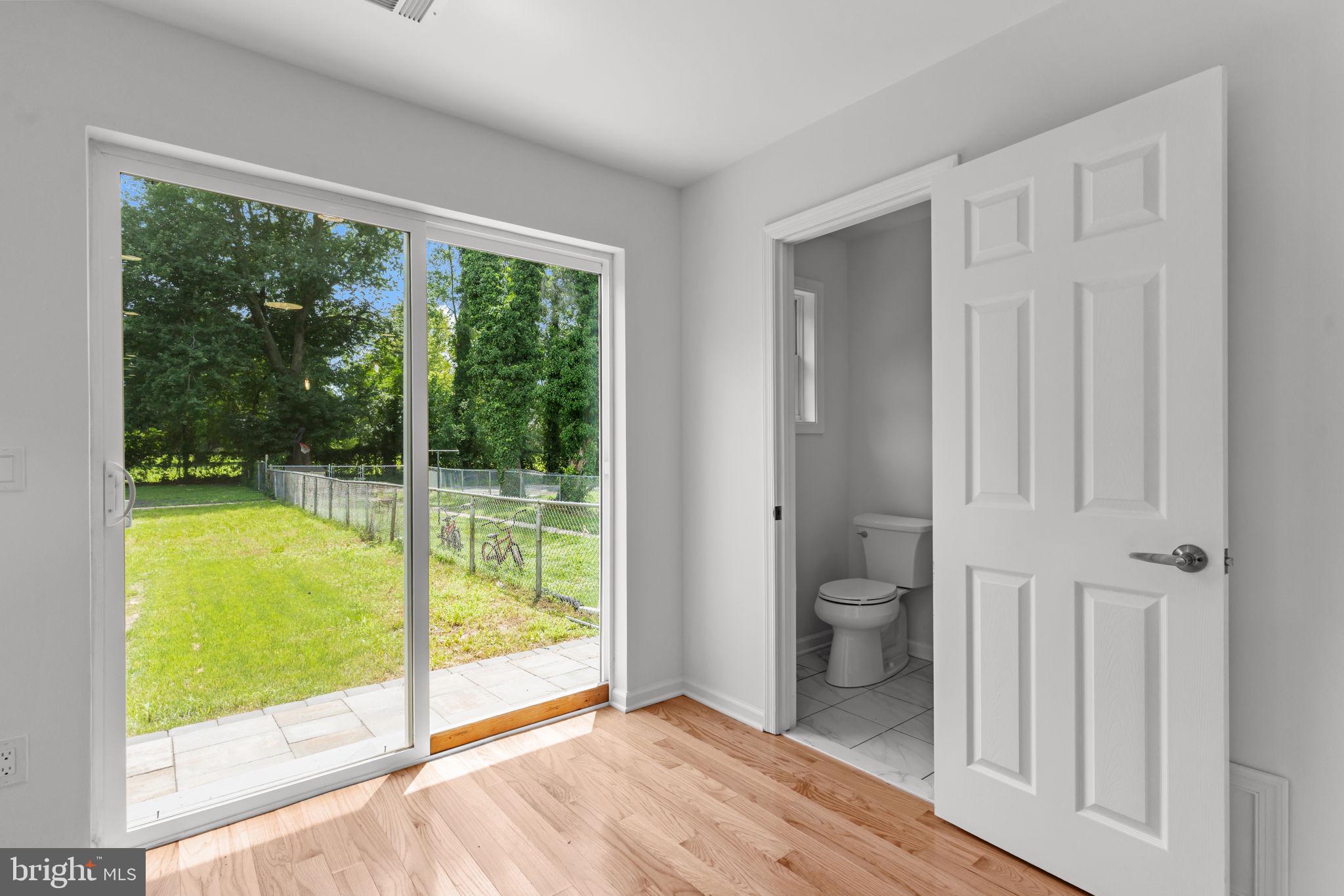 446 Pond Street Bristol, PA 19007 - Photo 16 of 35 a view of a room with a large window and wooden floor