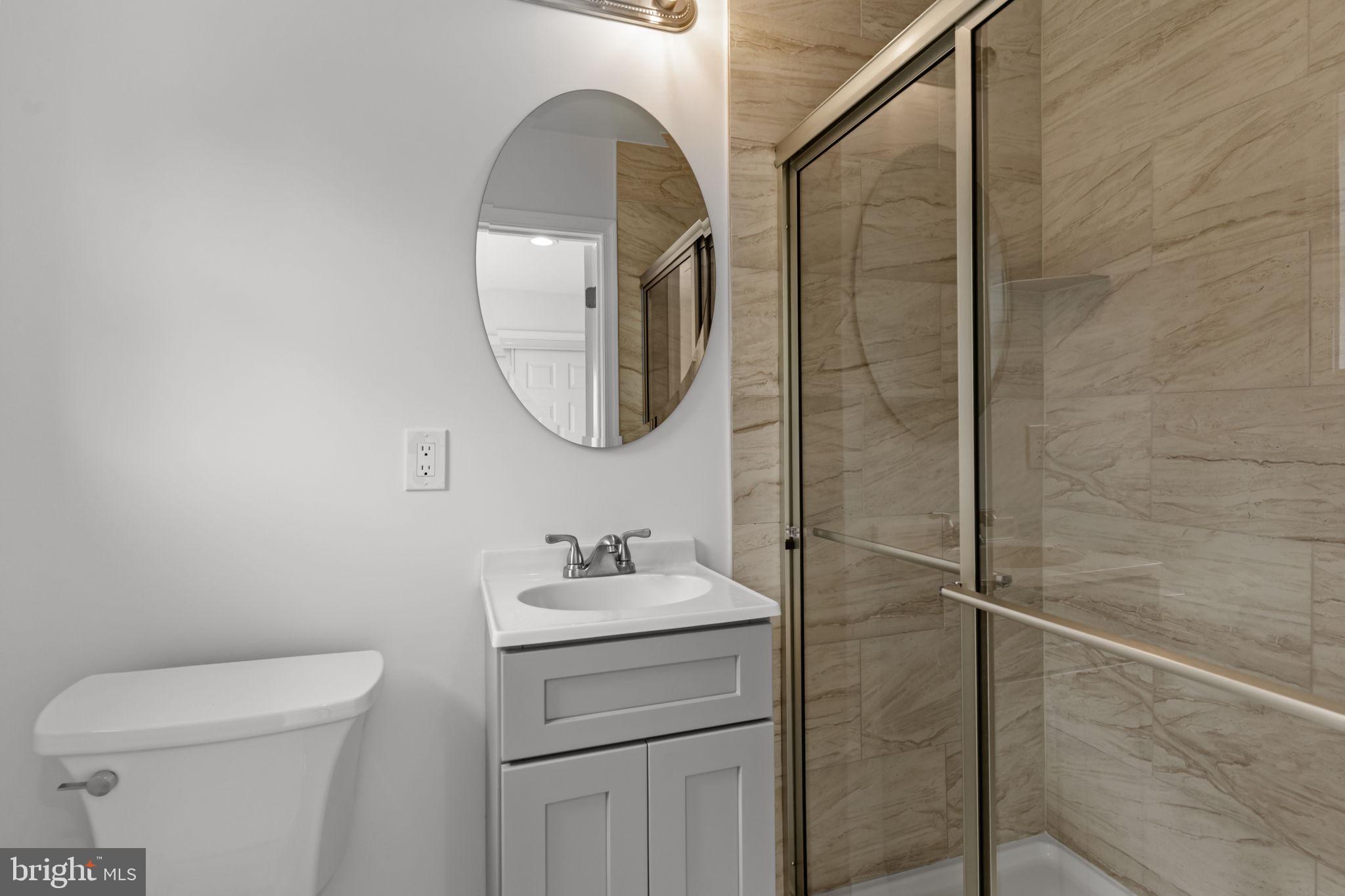 446 Pond Street Bristol, PA 19007 - Photo 18 of 35 a bathroom with a toilet sink vanity and mirror