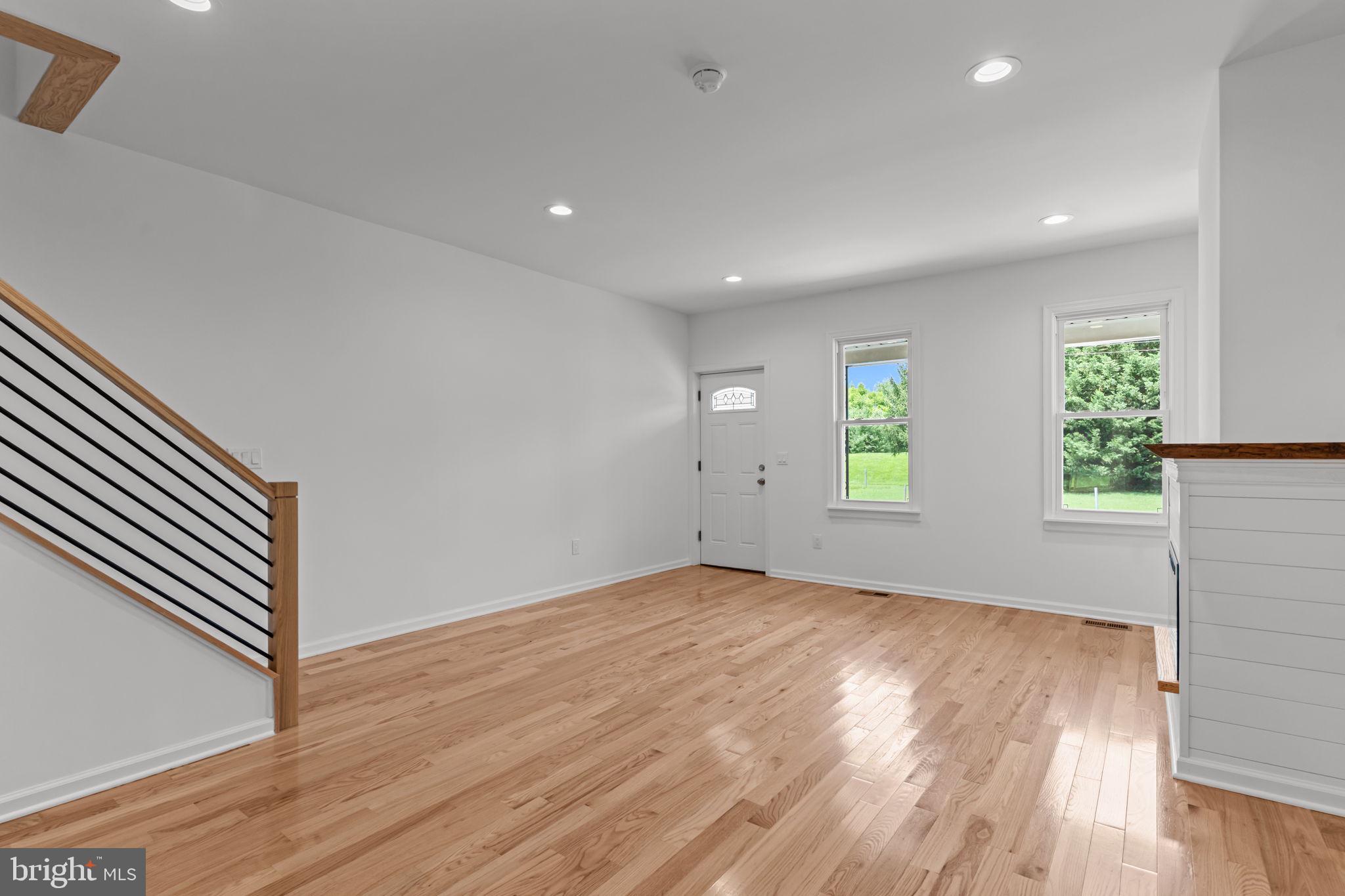 446 Pond Street Bristol, PA 19007 - Photo 9 of 35 an empty room with wooden floor and windows