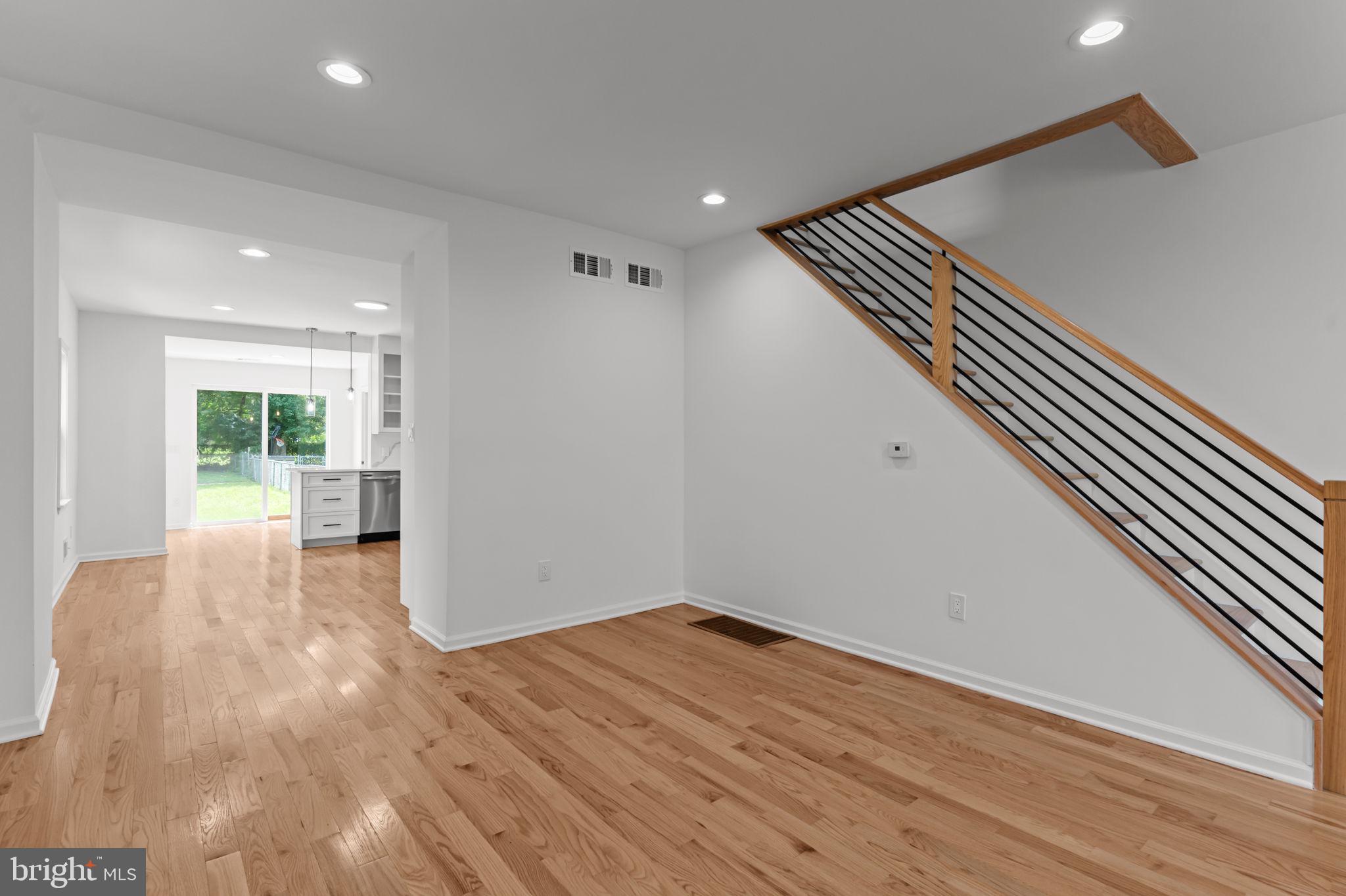 446 Pond Street Bristol, PA 19007 - Photo 10 of 35 a view of an empty room with wooden floor and a window