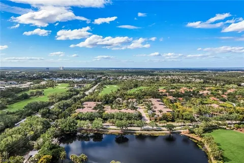 a view of a city with lots of residential buildings lake and mountain view in back