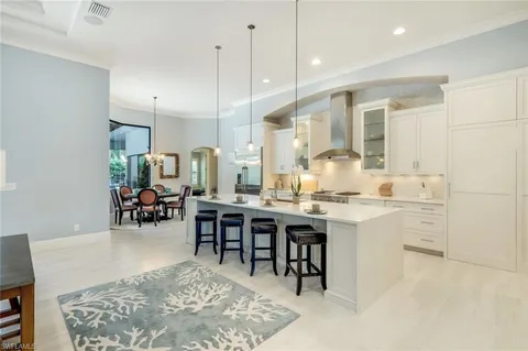 a large kitchen with a table and chairs