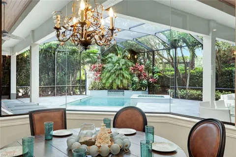 a kitchen with dining table and a large window