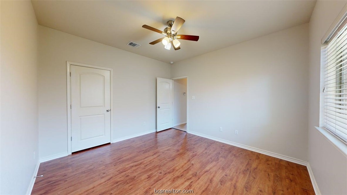 4453-4455 Reveille Road College Station, TX 77845 - Photo 16 of 37 an empty room with wooden floor closet and windows