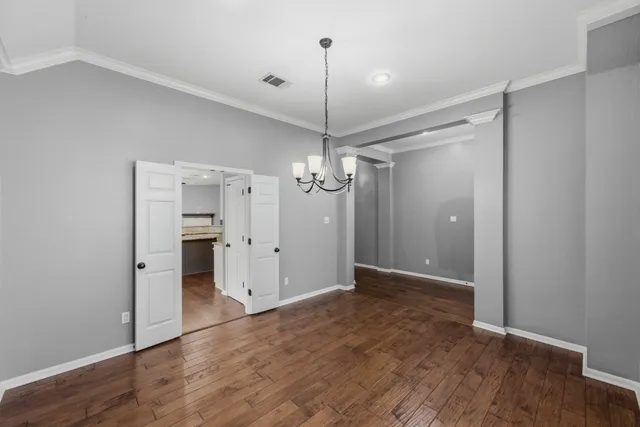 a view of a kitchen with a sink and wooden floor
