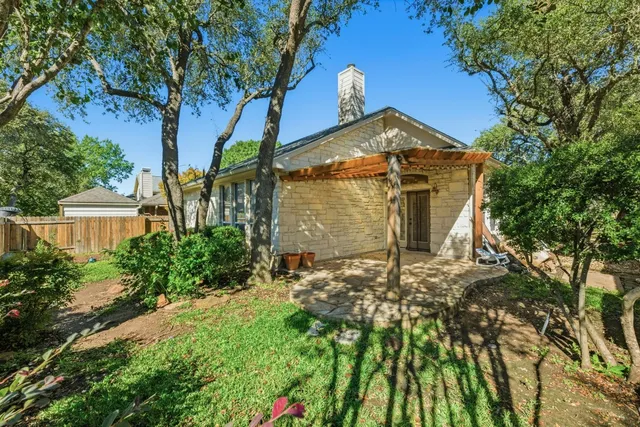 a front view of a house with a yard and balcony