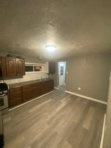a view of a kitchen with stove and cabinets