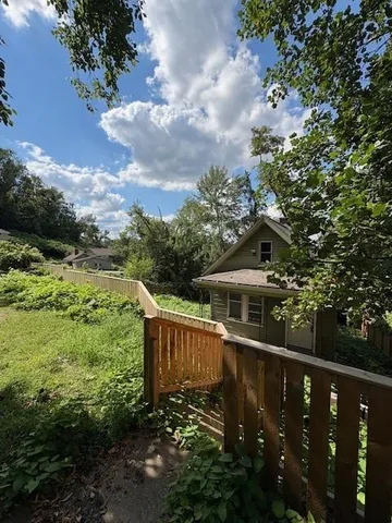 a view of a house with wooden fence