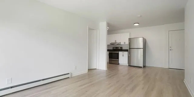 a kitchen with a refrigerator and a stove top oven