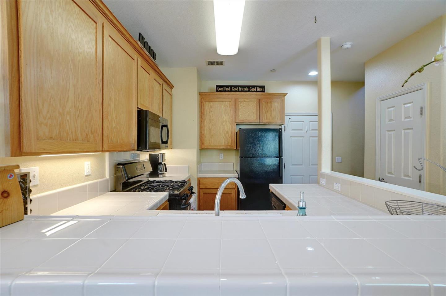 15525 Watsonville Road Morgan Hill, CA 95037 - Photo 12 of 36 a living room with a couch and a flat screen tv