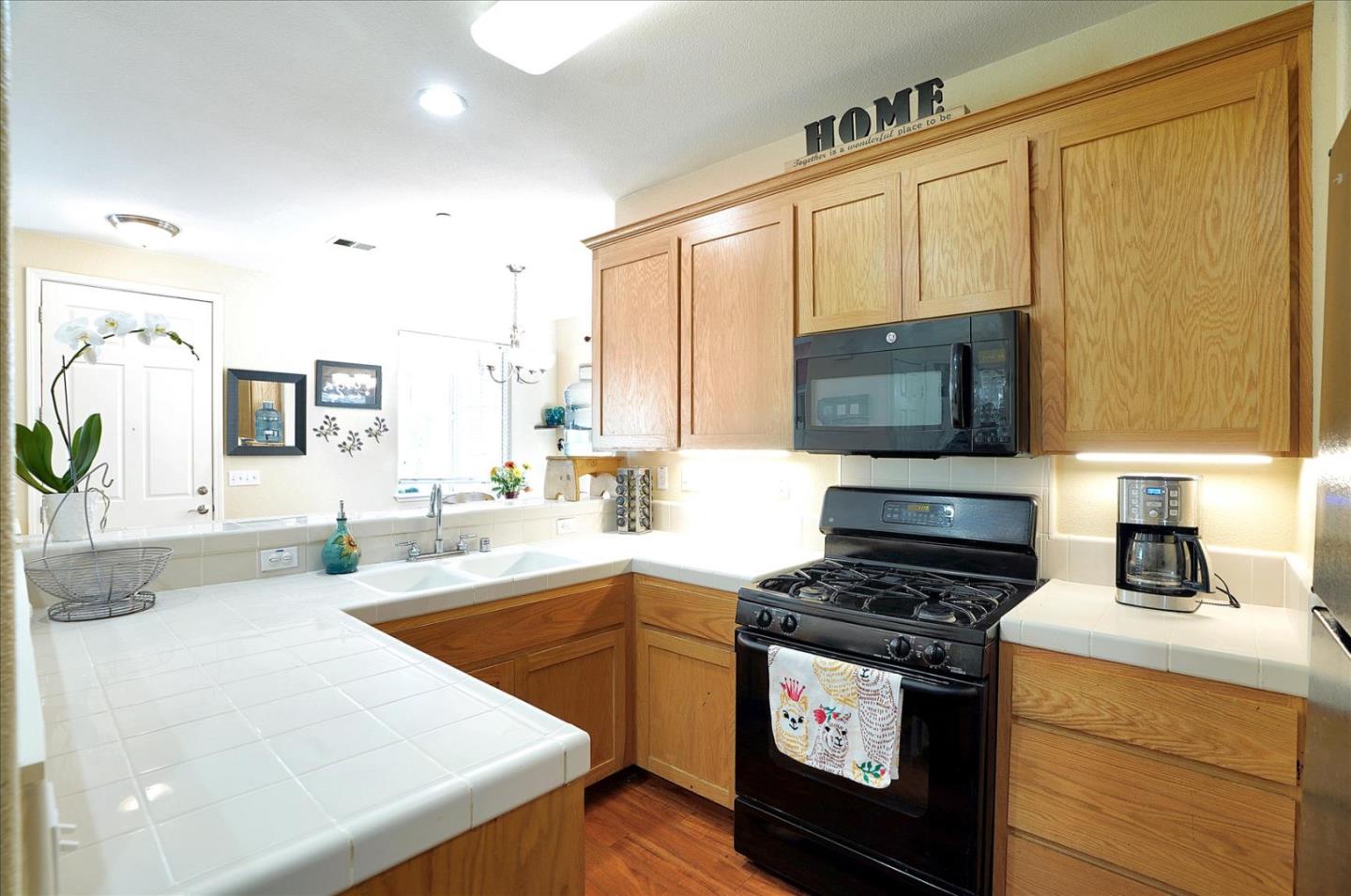 15525 Watsonville Road Morgan Hill, CA 95037 - Photo 13 of 36 a kitchen with stainless steel appliances a stove microwave and sink