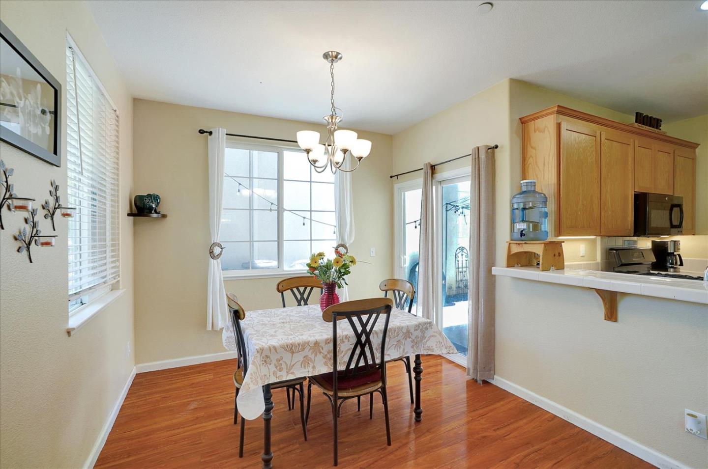 15525 Watsonville Road Morgan Hill, CA 95037 - Photo 15 of 36 a dining room with furniture a chandelier and wooden floor
