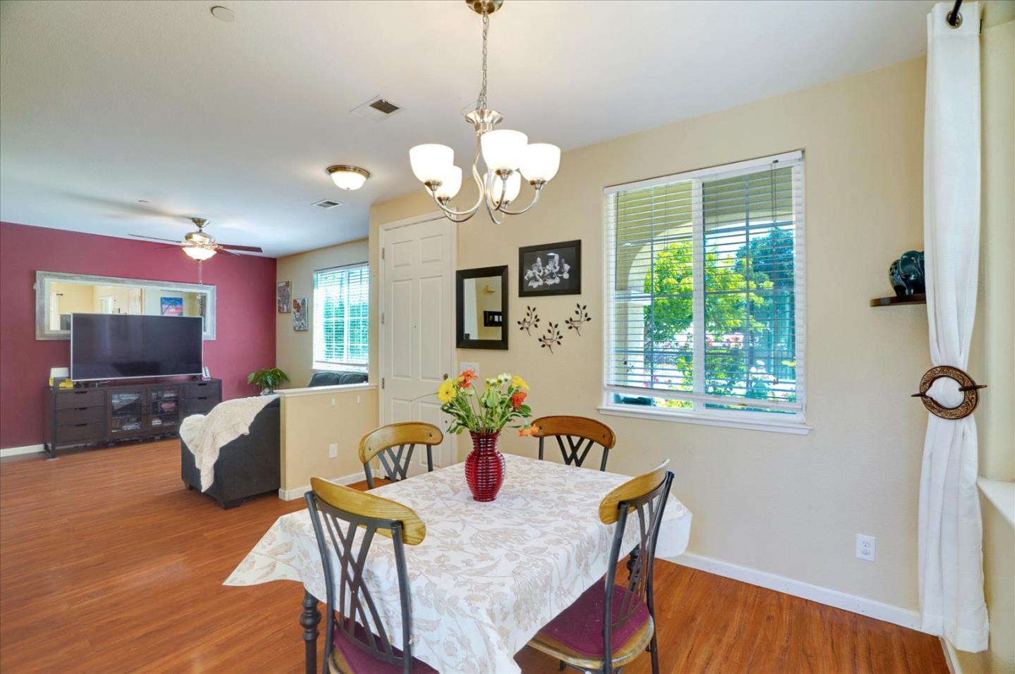 15525 Watsonville Road Morgan Hill, CA 95037 - Photo 17 of 36 a view of a dining room with furniture a chandelier and wooden floor