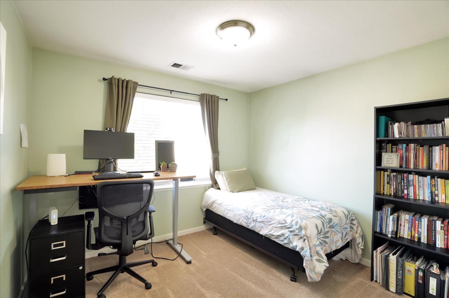 15525 Watsonville Road Morgan Hill, CA 95037 - Photo 22 of 36 a bedroom with a bed a book shelf and a window