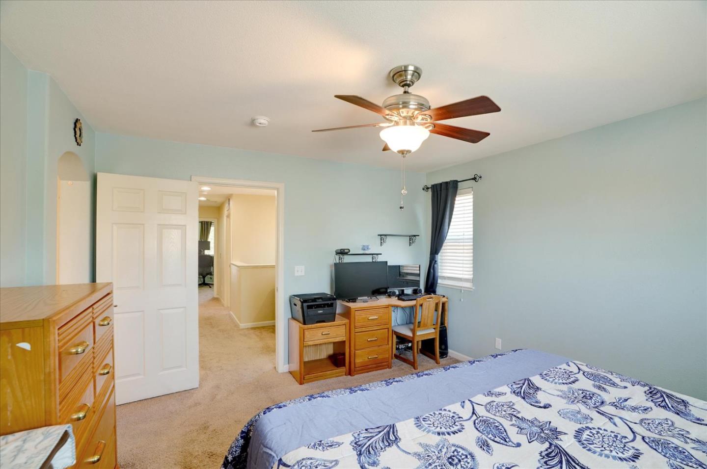 15525 Watsonville Road Morgan Hill, CA 95037 - Photo 27 of 36 a bed room with a bed and a chandelier