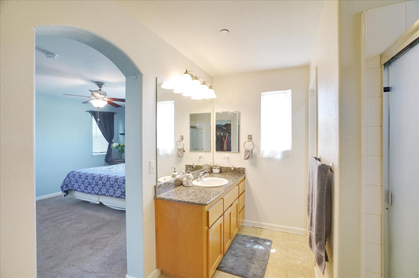 15525 Watsonville Road Morgan Hill, CA 95037 - Photo 28 of 36 a bathroom with a granite countertop sink and a mirror
