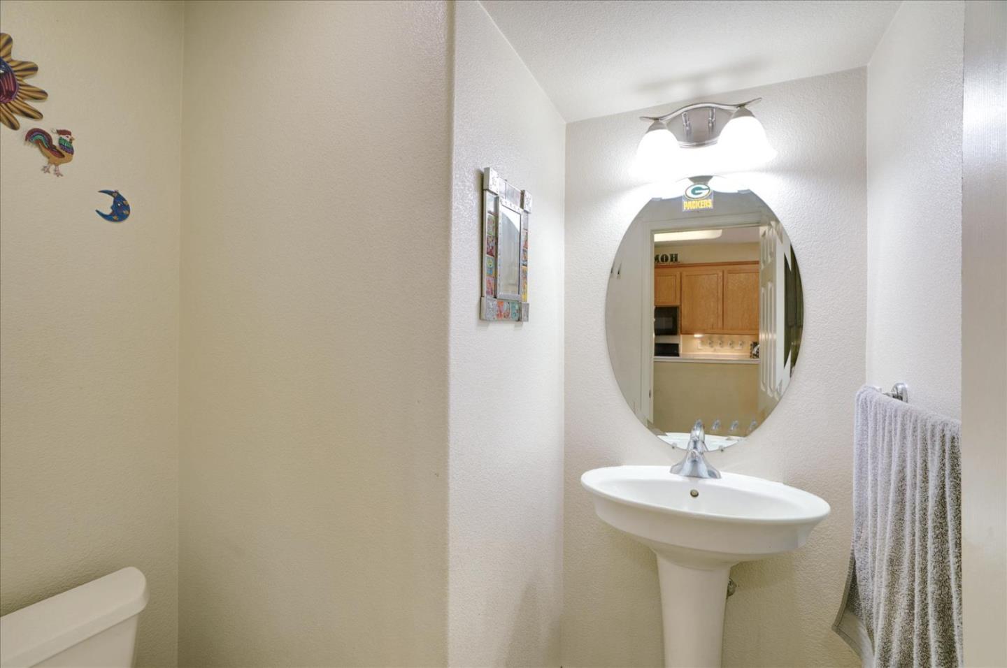 15525 Watsonville Road Morgan Hill, CA 95037 - Photo 31 of 36 a bathroom with a toilet sink and mirror