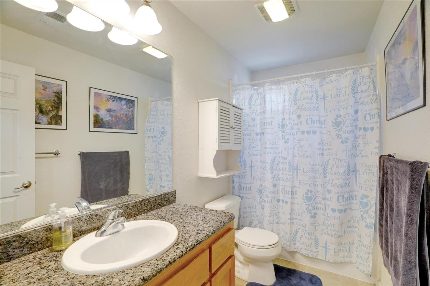 15525 Watsonville Road Morgan Hill, CA 95037 - Photo 32 of 36 a bathroom with a sink toilet and a mirror