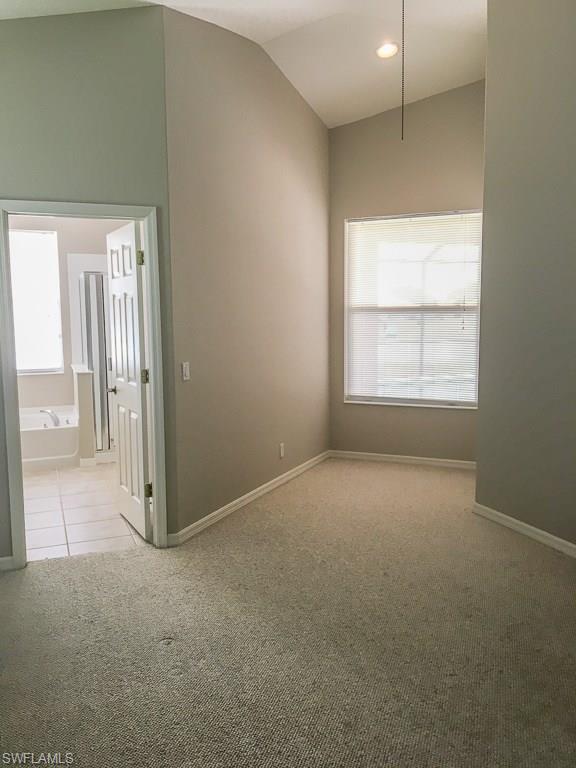 2161 Rusty Fig Court Naples, FL 34120 - Photo 11 of 17 an empty room with windows