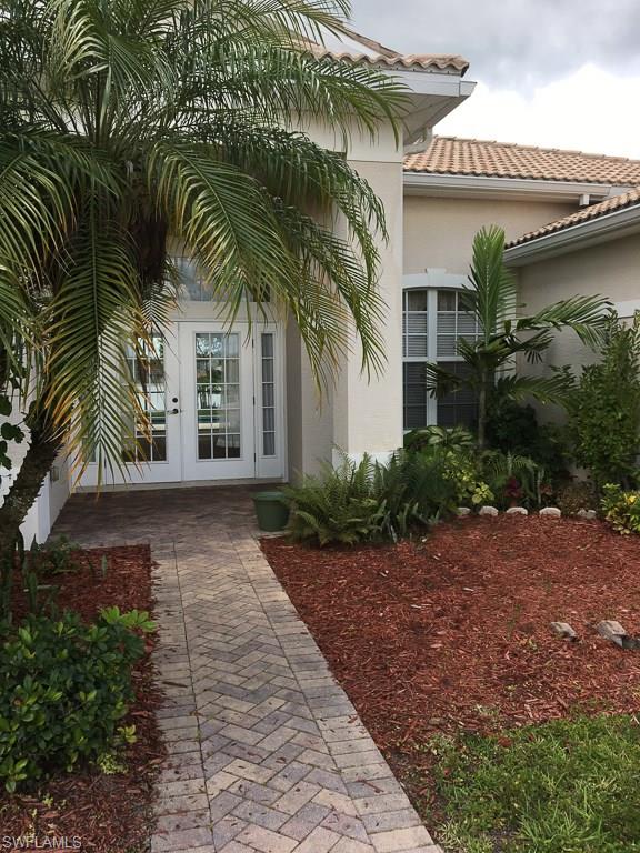 2161 Rusty Fig Court Naples, FL 34120 - Photo 2 of 17 a view of a house with a yard