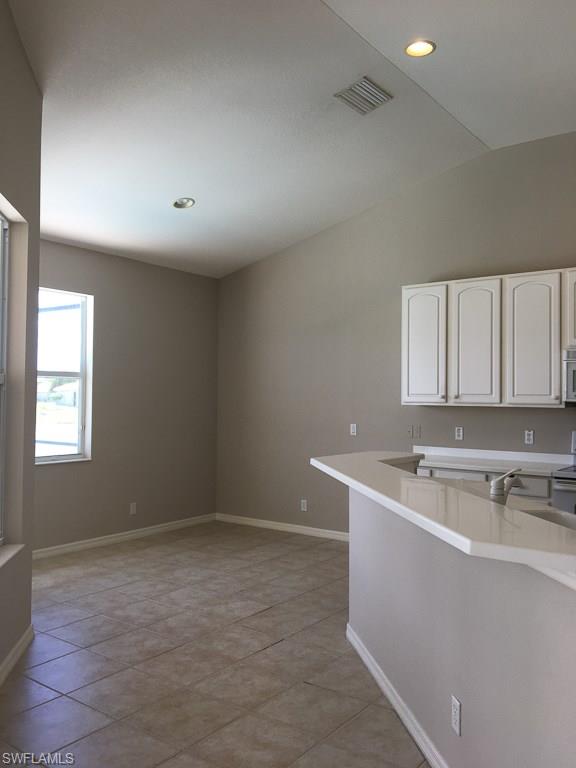 2161 Rusty Fig Court Naples, FL 34120 - Photo 8 of 17 a room with a sink cabinets and utility