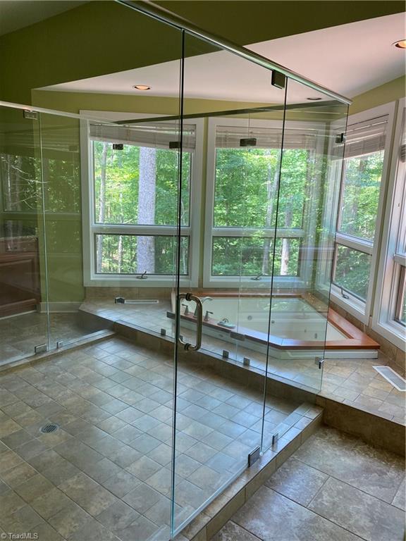 800 Scott Road Lewisville, NC 27023 - Photo 18 of 30 Spacious master shower with sunken bathtub overlooking the trees