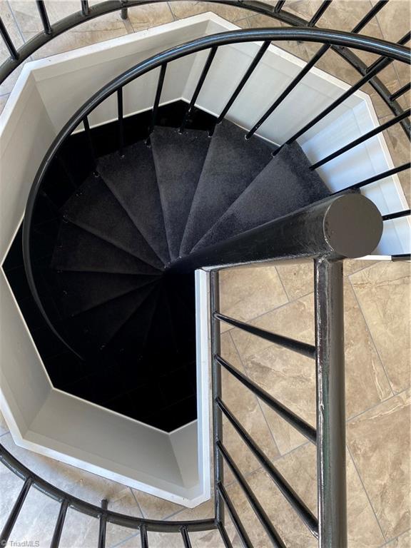 800 Scott Road Lewisville, NC 27023 - Photo 23 of 30 Spiral staircase going down to wine cellar and tasting/storage room