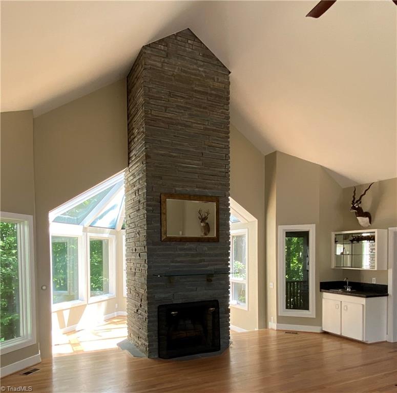 800 Scott Road Lewisville, NC 27023 - Photo 6 of 30 Great Room fireplace with wet bar and step down sunroom