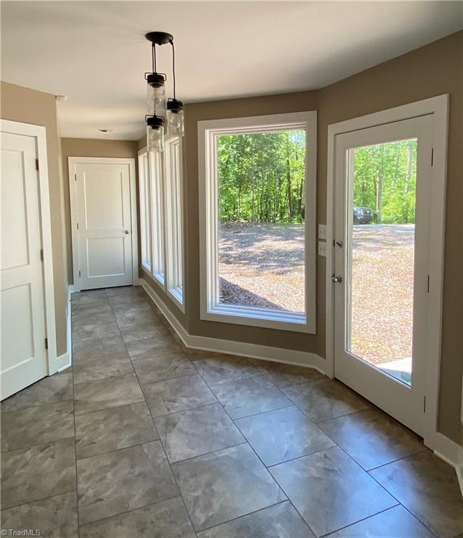 800 Scott Road Lewisville, NC 27023 - Photo 9 of 30 Dining room leading to outdoor screen porch and to kitchen