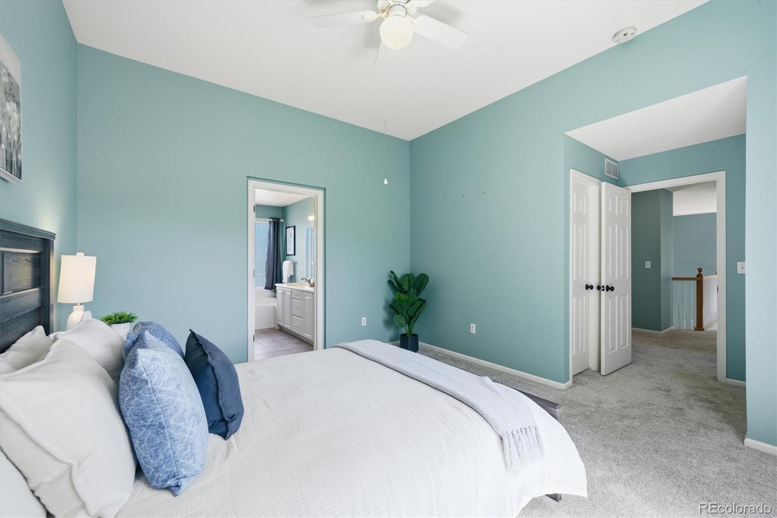 9629 Burberry Way Highlands Ranch, CO 80129 - Photo 26 of 50 a bedroom with a bed and a chandelier